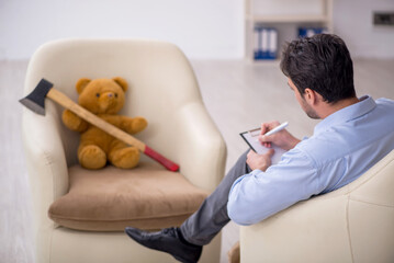 Young male psychologist meeting with toy bear