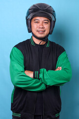 Portrait of online driver man in uniform wearing motorbike helmet confidently standing crossed arms and smiling