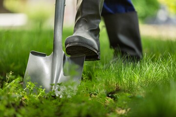 Farmer working in garden digging soil. Farming garden work.