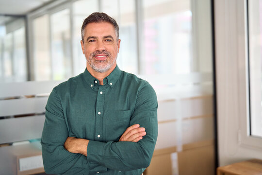 Smiling 40 years old middle aged business man in office, portrait. Confident older bank manager or investor, mid adult businessman boss, successful professional Indian entrepreneur looking at camera.