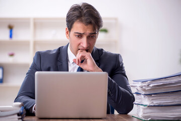 Young male employee working in the office