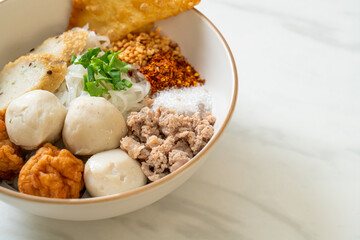 spicy small flat rice noodles with fish balls and shrimp balls without soup