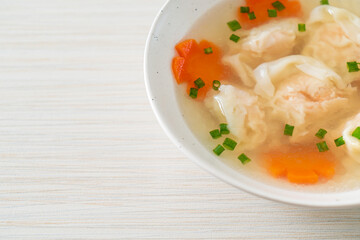 shrimp dumpling soup in white bowl