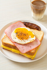 bread toasted cheese topped ham and fried egg with pork sausage