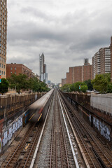 A subway train runs through Harlem in New York City, USA.