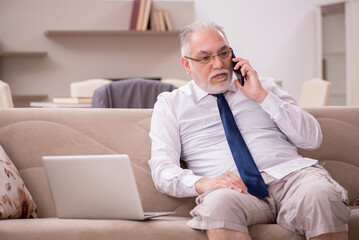 Old male employee working from home during pandemic