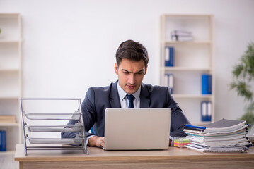 Fototapeta premium Young male employee working in the office