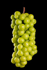 one bunch of fresh green shine muscat grape isolated on black background