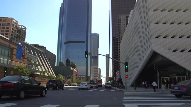 The Broad art Museum with downtown skyscrapers financial district passing traffic in downtown Los Angeles