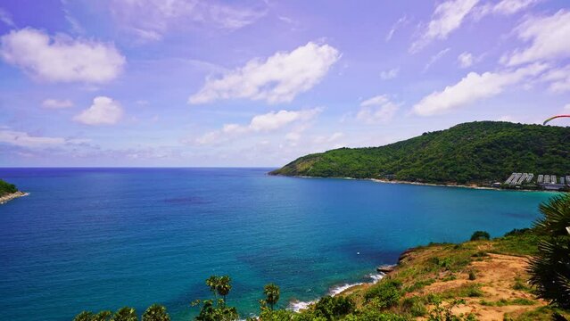 Paragliding sport over the phuket island Thailand,Amazing seashore tropical sea on background,Extreme activity on west coast of Phuket Island,Paragliding spot at seaboard,Fabric wing soar in air