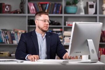 Man in dark office working on pc