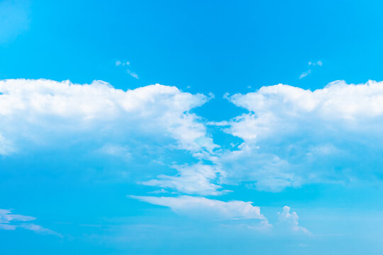White clouds on gradient blue sky background
