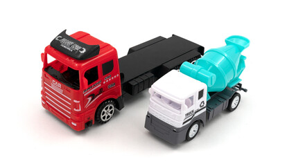 Toy truck with trailer transports cement mixer on white background.