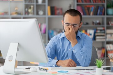 Businessman with stressed working in office on computer