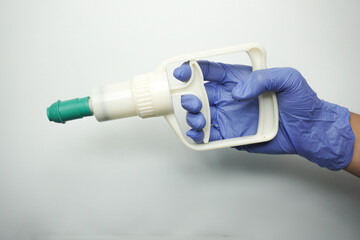 holding cupping pump and wearing medical gloves isolated on white