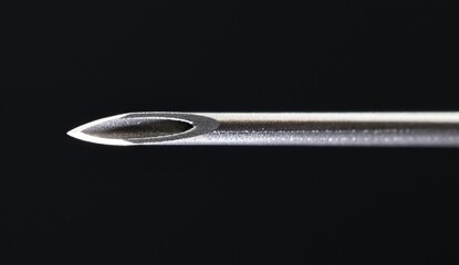 Extreme macro close-up of a sterile pristine 22 gauge medical needle bevel, showcasing its razor-sharp tip