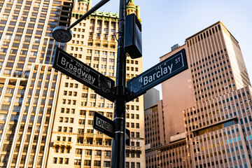 New York City, USA - May 12, 2023: street name sign with lamp at Manhattan Broadway and Barclay...
