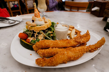 Fish and chips recipes with salad at a restaurant