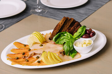 White and red smoked fish slices with glasses of wine