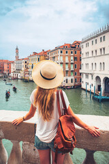 Woman tourist admiring Venice canal and building- tour tourism, vacation or travel destination...