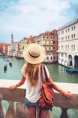 Fotobehang Woman tourist admiring Venice canal and building- tour tourism, vacation or travel destination concept © M.studio