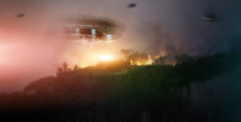 Night, ufo and spaceship in sky at forest in countryside, trees on fire and invasion in nature....