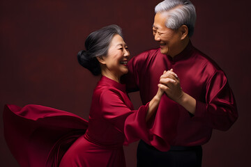 Colorful studio portrait of an elderly asian couple dancing, Silver & Burgundy. Generative AI