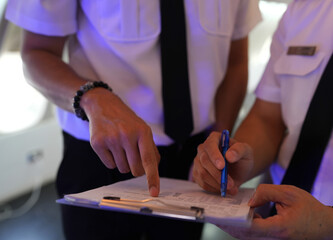 pilots preparing flight documentation before take off and landing.