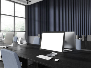 Blank computer screen in blue office