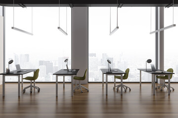 Modern office interior with table and chairs in row, laptop and window