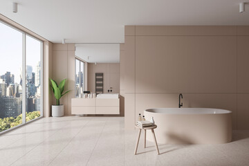 Fototapeta na wymiar Stylish beige bathroom interior with bathtub and sink, window and empty wall