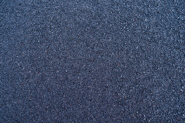 Fototapeta premium Black sand as a background. Photo for the design. Textures in nature. Image for background and wallpaper.