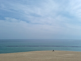 Fototapeta na wymiar Sea and sandy beach with blue sky