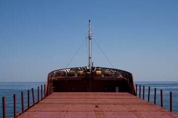 General, dry cargo ship with empty cargo deck at sea on his way to loading port