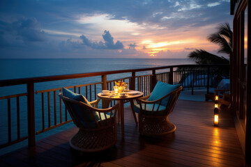 Restaurant overlooking the sunset over the ocean. A table in a restaurant on the veranda overlooking the ocean. Romantic evening - obrazy, fototapety, plakaty