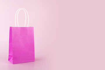 online shopping background, sale and discount, shopping bag on pink background