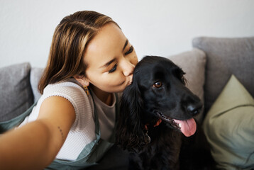 Kiss, selfie and woman with dog on home sofa to relax, love and play with animal. Pet owner, care...