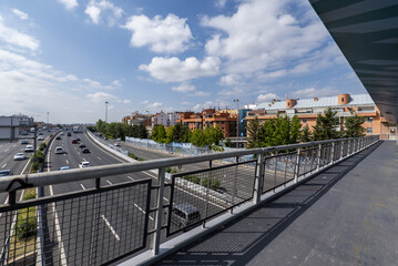 A metal walkway over an urban highway