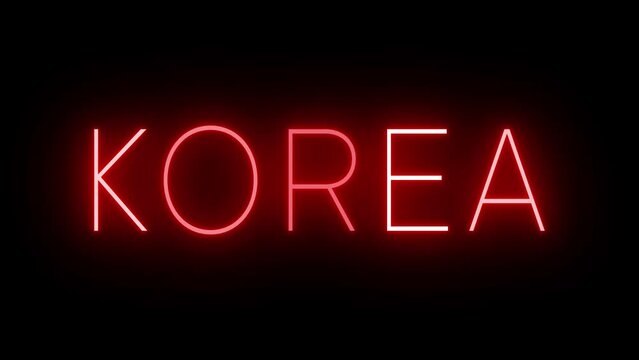 Flickering red retro style neon sign glowing against a black background