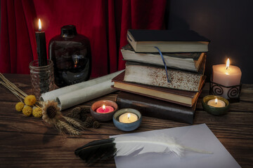 A still life with some dried flowers, some lit candles