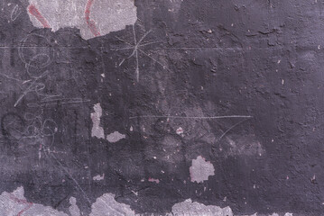 A wall painted with black paint with many obvious chips
