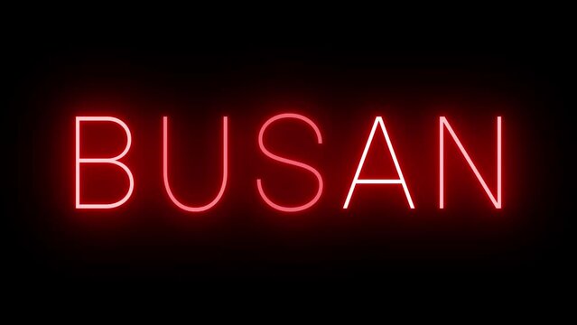 Flickering red retro style neon sign glowing against a black background