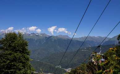 beautiful landscape - panoramic view of mountains and Krasnaya Polyana in Sochi on a sunny summer day and copy space