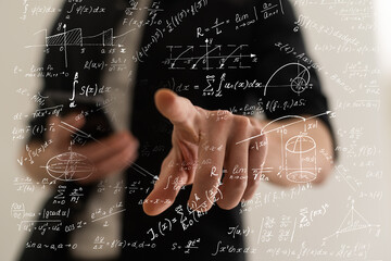 Businessman writing math formulas finger