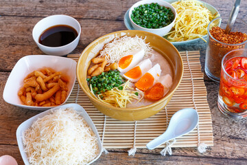 Congee, rice porridge with salted egg, leek, and ginger. Asian healthy meal, favorite breakfast for Southeast Asian people.