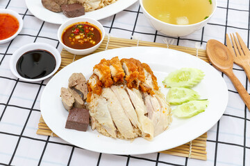Hainanese chicken rice and chicken fried with soup in the background. thai food concept.
