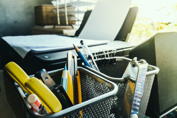 Close up of stationary items such as pencils, scissors, cutter knives, and paper clips are placed...