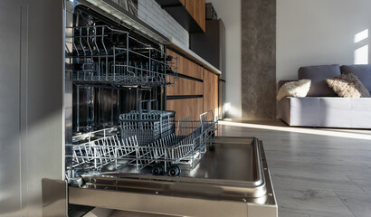 Open dishwasher with clean dishes in the white kitchen.