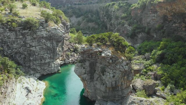 Aerial video of the mountain Moracha River canyon in Montenegro. Relax natural scenery, wild nature landscape, towering cliffs, clear river, green tourism, wanderlust.