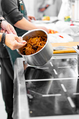 Chef cook hand cooking cabbage food at the restaurant kitchen
